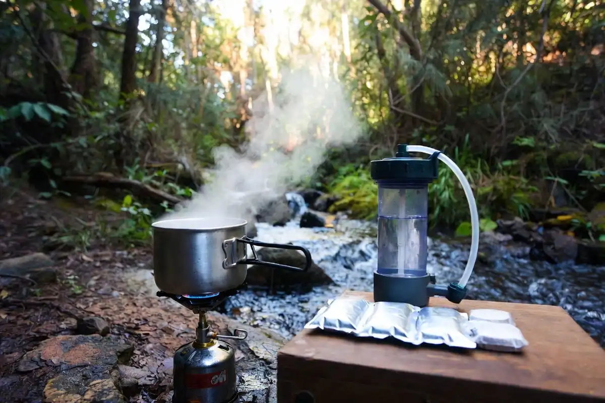 boiling and filtering water at campsite