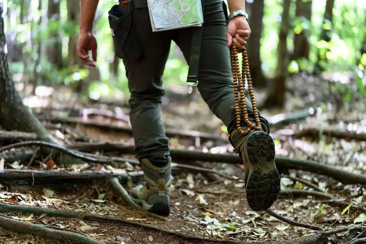 pace beads and watch used while hiking a wooded path