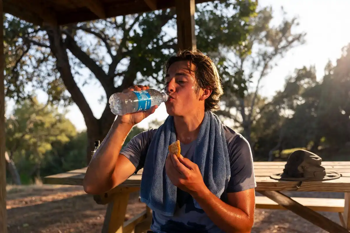rehydrating after a hot weather hike at the trailhead