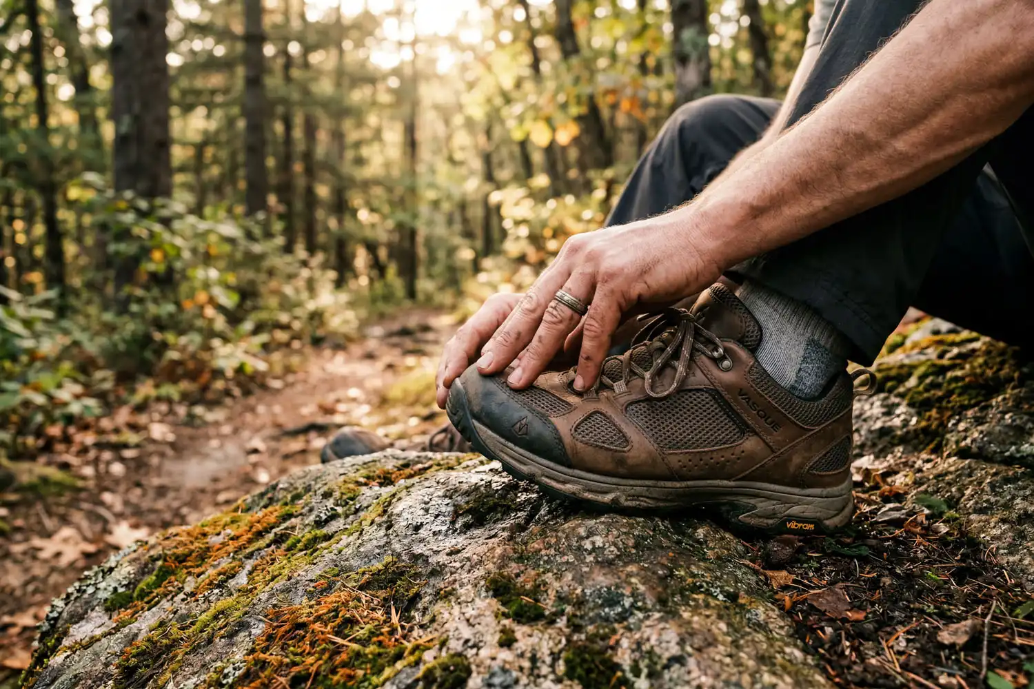 Hiker checking hiking shoe fit on trail
