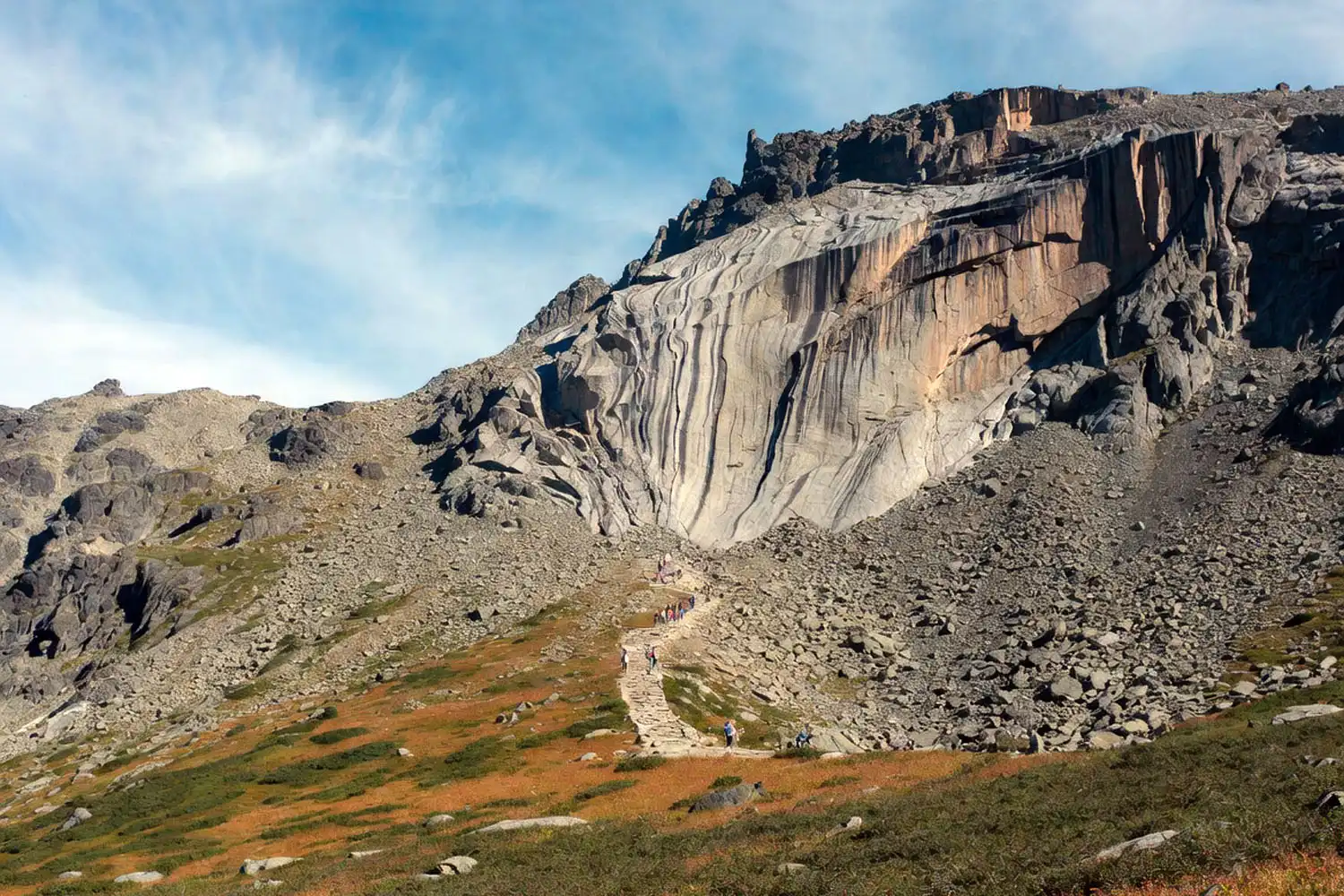 Steep glacial bowl of Tuckerman Ravine on Mount Washington with a rocky trail winding up the headwall